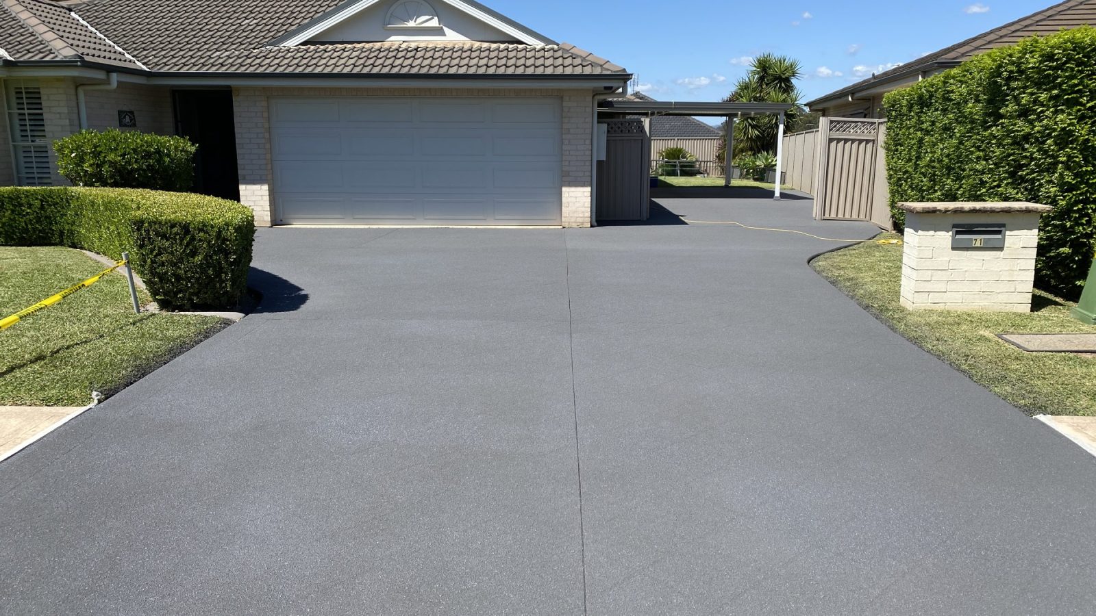 Driveway after stencil pattern removal, resurfaced to a level uniform finish