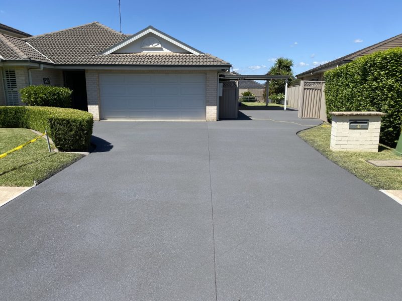 Driveway after stencil pattern removal, resurfaced to a level uniform finish